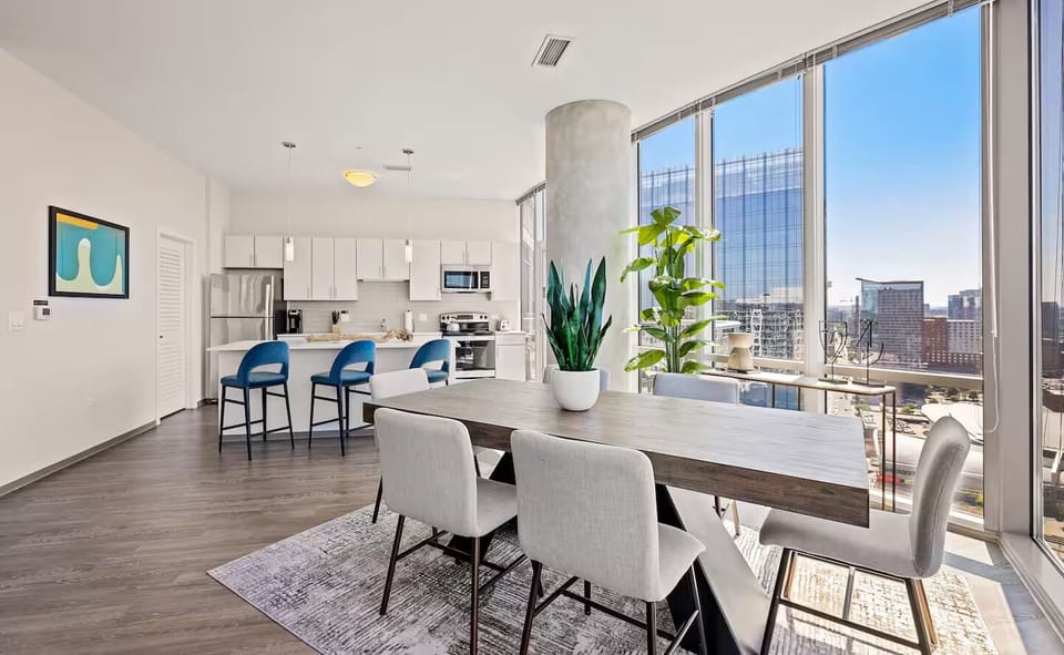 Settle into cozy conversation corners framed by dramatic city windows.