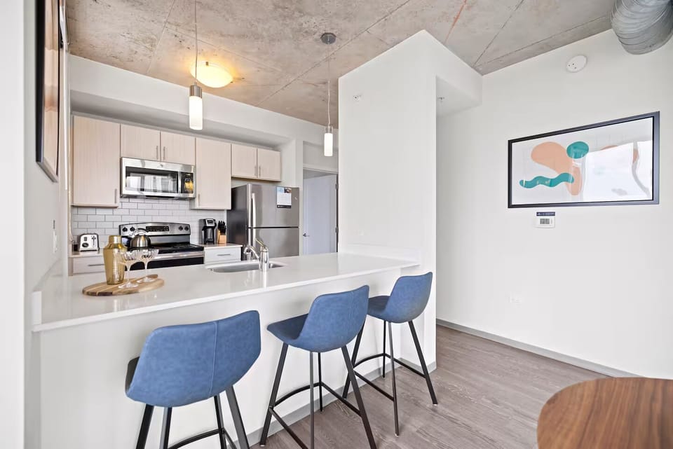 Cook and connect around the sleek island with bar seating.