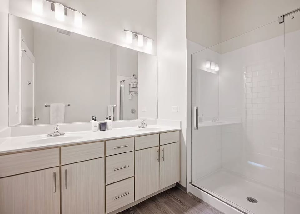 Refresh in a bright bath with a spacious glass shower.