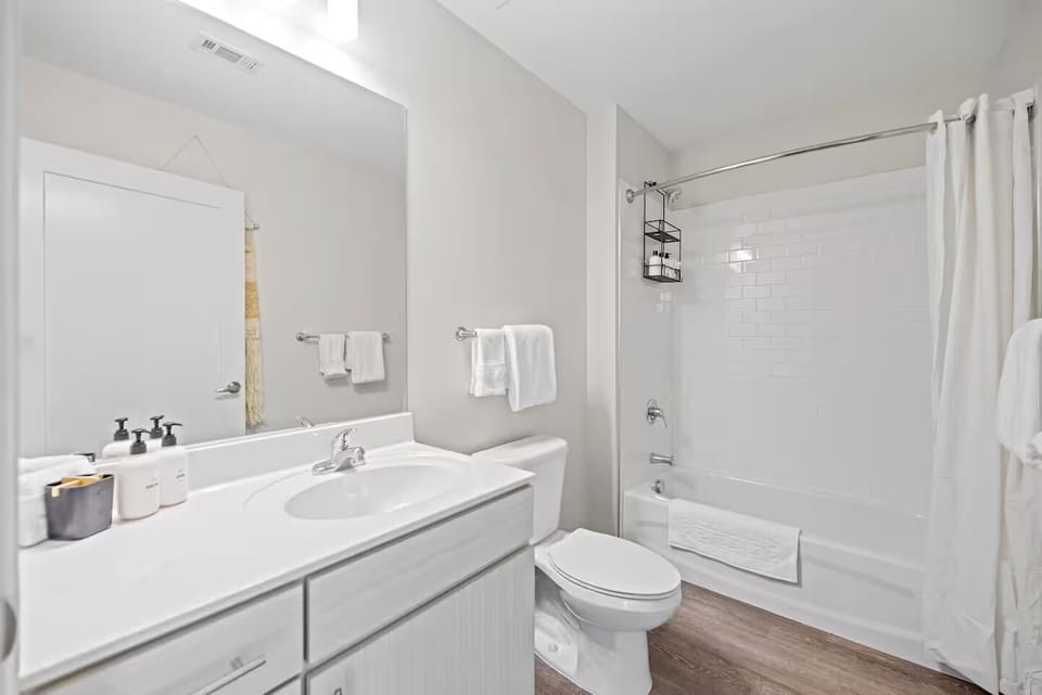 Refresh in a spotless bath with fluffy towels and tub.