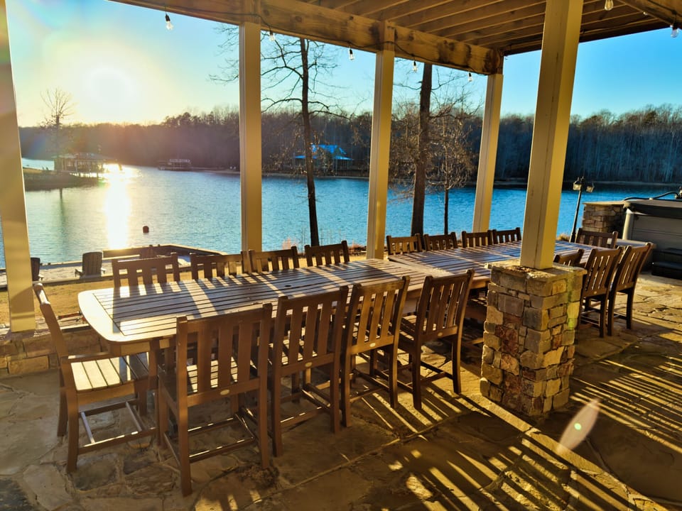 Waterfront patio dining for a crowd with sunset views and hot tub