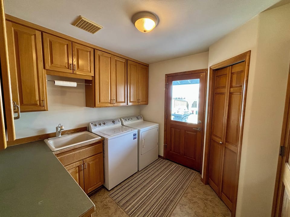 Laundry room off kitchen, door to back yard and outdoor dining area