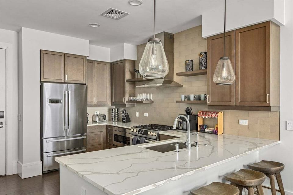 Kitchen with 5 burner gas stove, dishwasher, microwave, Keurig Duo and refrigerator