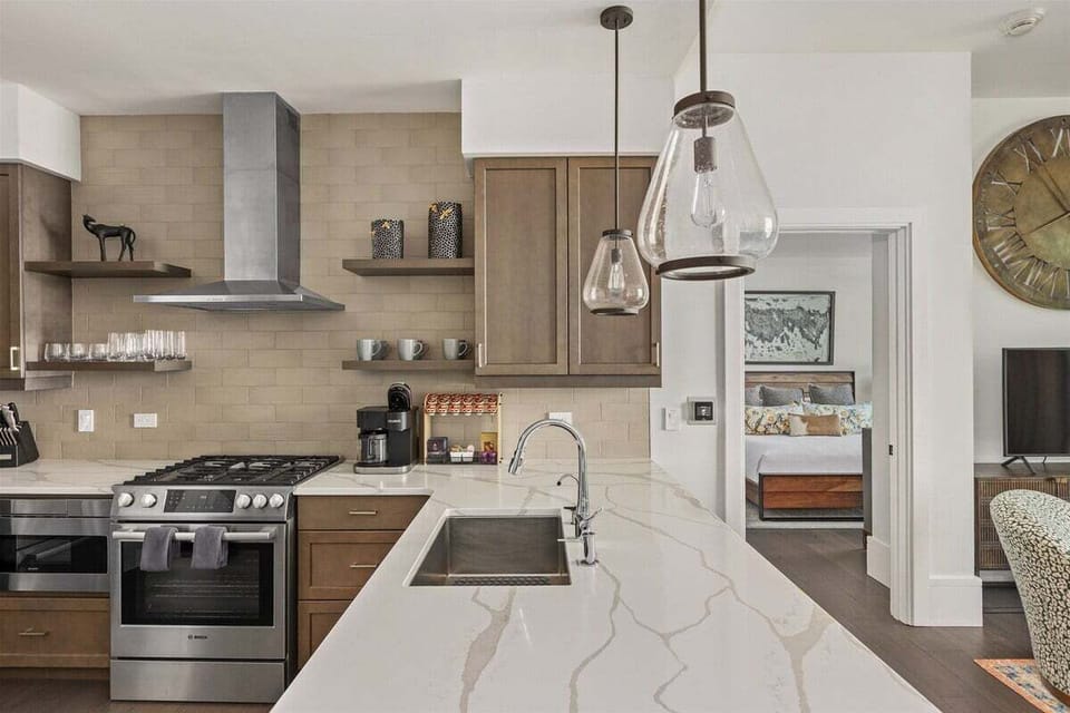 Kitchen with 5 burner gas stove, dishwasher, microwave, Keurig Duo and refrigerator