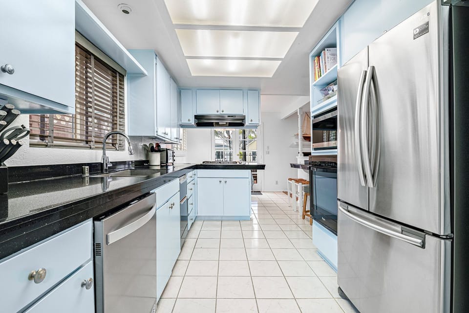 Well-equipped and functional, the kitchen is designed for both quick bites and relaxed home-cooked meals
                