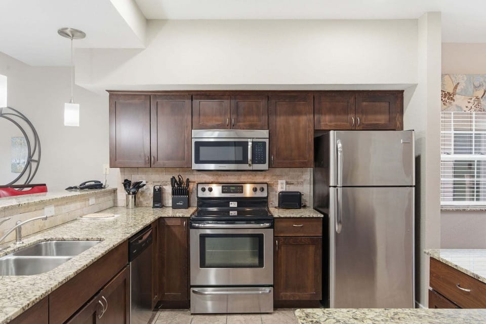 Full Kitchen with Upgraded Appliances and Additional Bar Seating