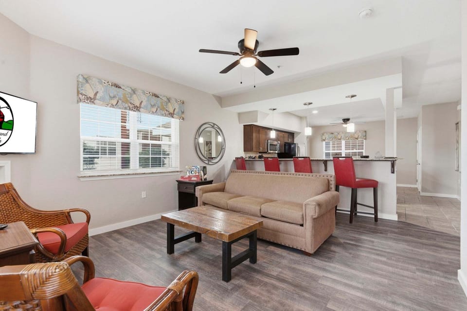 The living area is spacious and includes cable TV, a sleeper sofa, and patio access