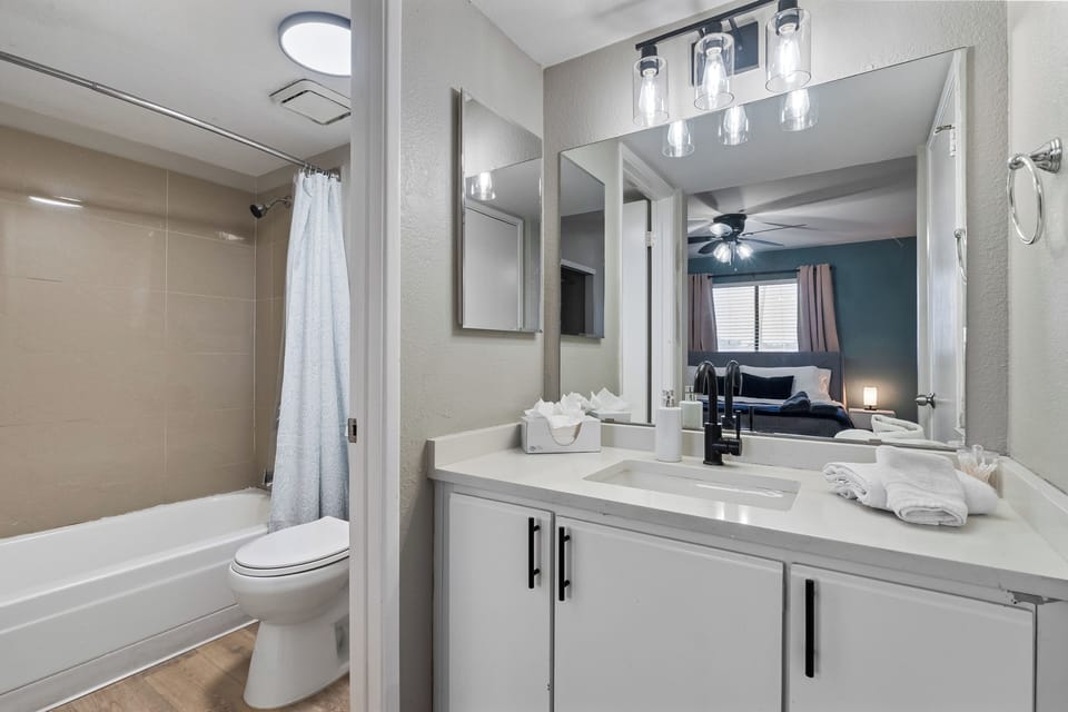 Well-lit and clean bathroom with complete basic essentials.