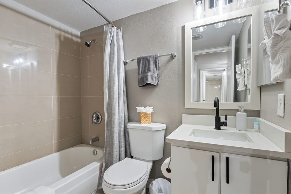 Well-maintained bathroom featuring a bathtub and all the necessities you need fo