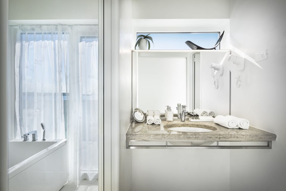 Luxury Suite, Sauna, Sea View | Bathroom | Combined shower/tub, free toiletries, hair dryer, bathrobes