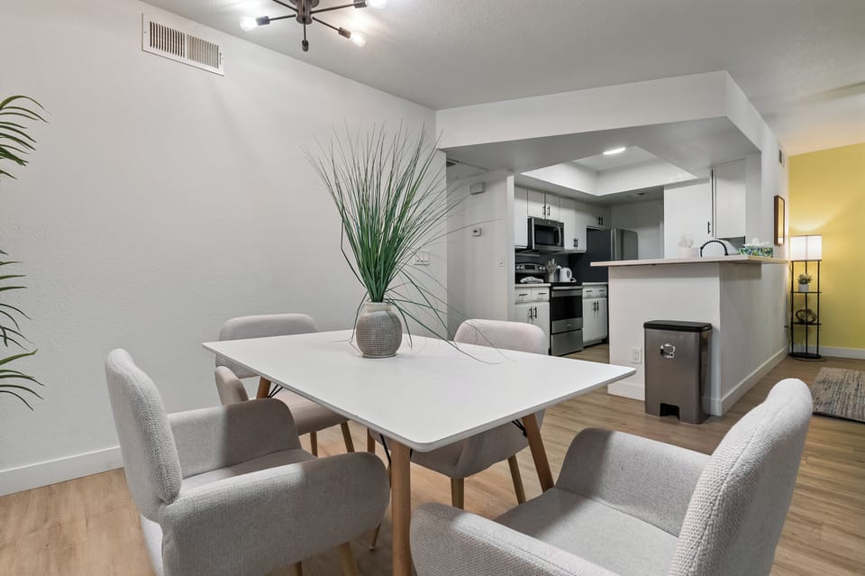 “Clean dining space with table and chairs in an open layout