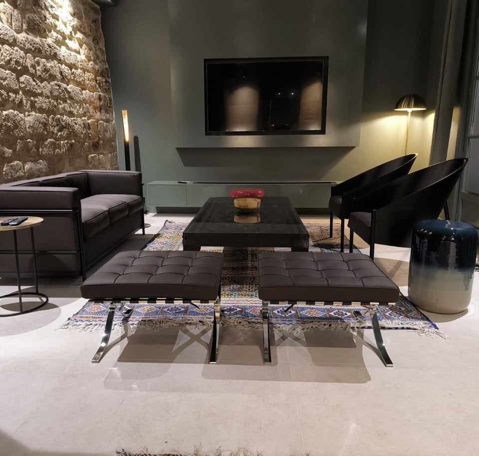 Living room, Le Corbusier sofa, Stark armchairs, Barcelona stool, Berber carpet
