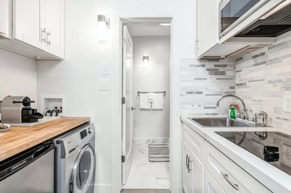 Your sleek galley kitchen features modern appliances, ample counter space, and convenient in-unit laundry for effortless meal prep and daily routines.