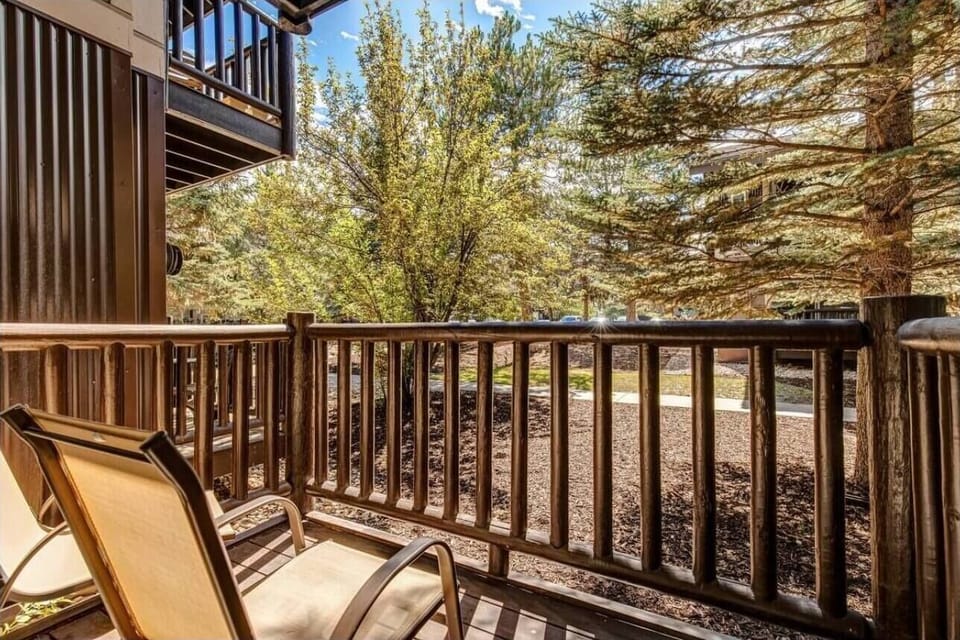 Step onto your private balcony and sink into comfortable seating while soaking up peaceful garden views surrounded by mature trees.