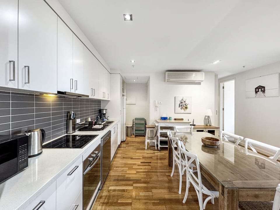 Enjoy the convenience of a full kitchen and large dining table, ideal for relaxed meals at home during your stay
