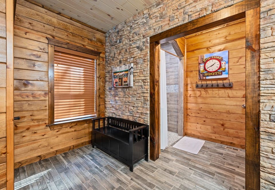 This bathroom space continues the clean and cohesive design with warm finishes and easy access from nearby rooms, offering both comfort and convenience for guests using this shared area.