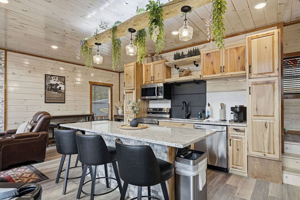 Gather around this stunning kitchen island where your group can cook together and share stories under charming hanging plants.