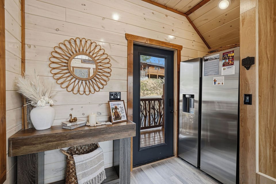 Step into your stylish mountain retreat where rustic wood meets modern comfort, complete with a full-sized refrigerator for all your culinary adventures.