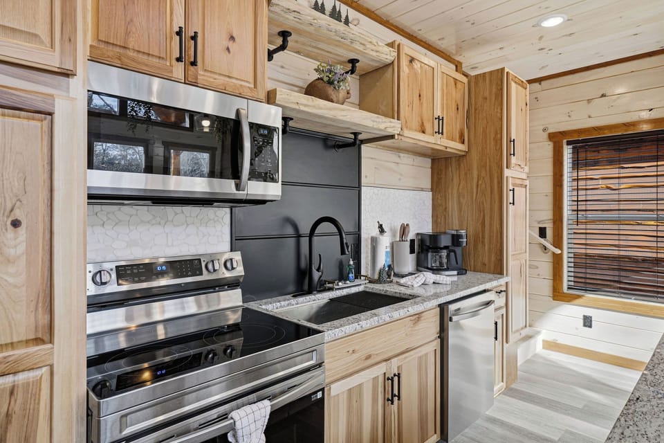 Your fully equipped kitchen features stainless steel appliances and warm wood cabinetry, perfect for preparing meals during your stay.