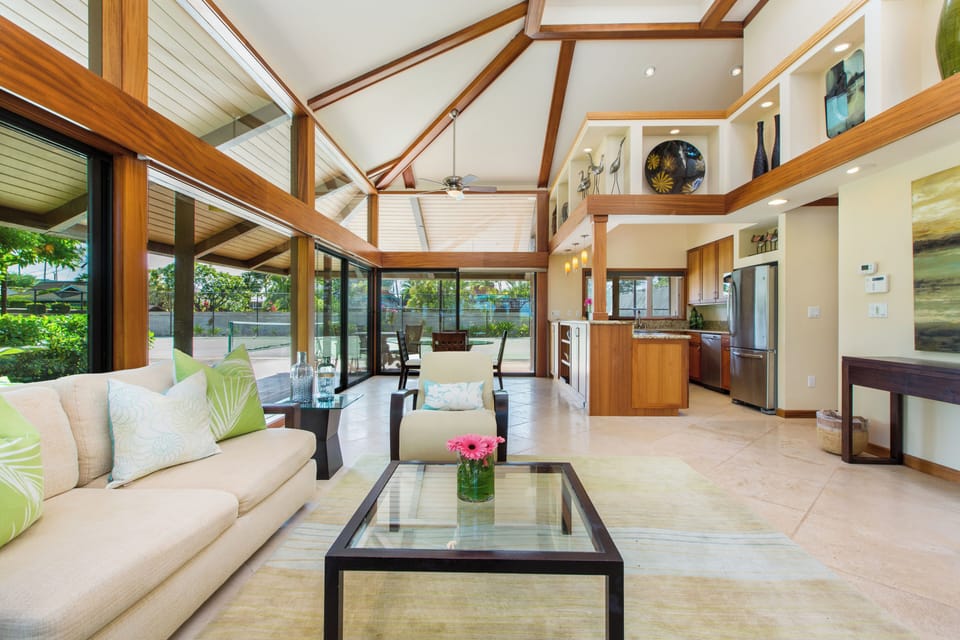 Gather in the airy guest house living space with soaring ceilings and island-style design.