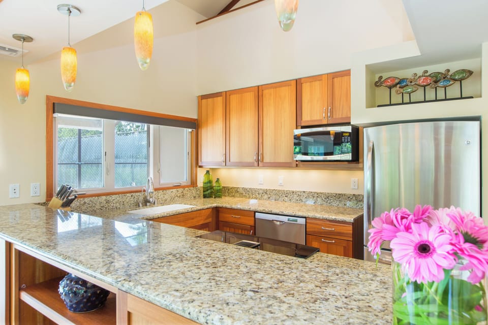 Prepare easy island meals in the guest house kitchen with granite countertops.
