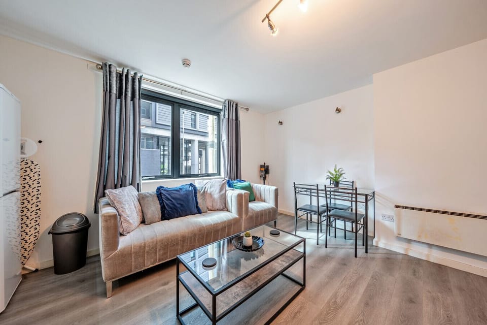 A simple lounge space for relaxing with a coffee table and seating near the window.