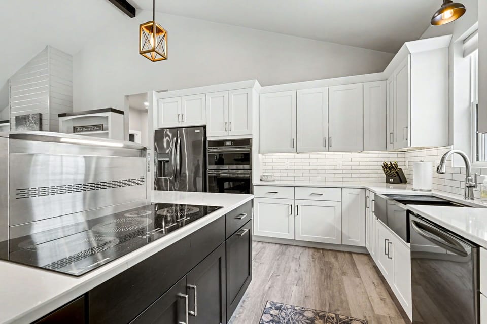 The kitchen is equipped with sleek stainless steel appliances, offering both style and functionality.