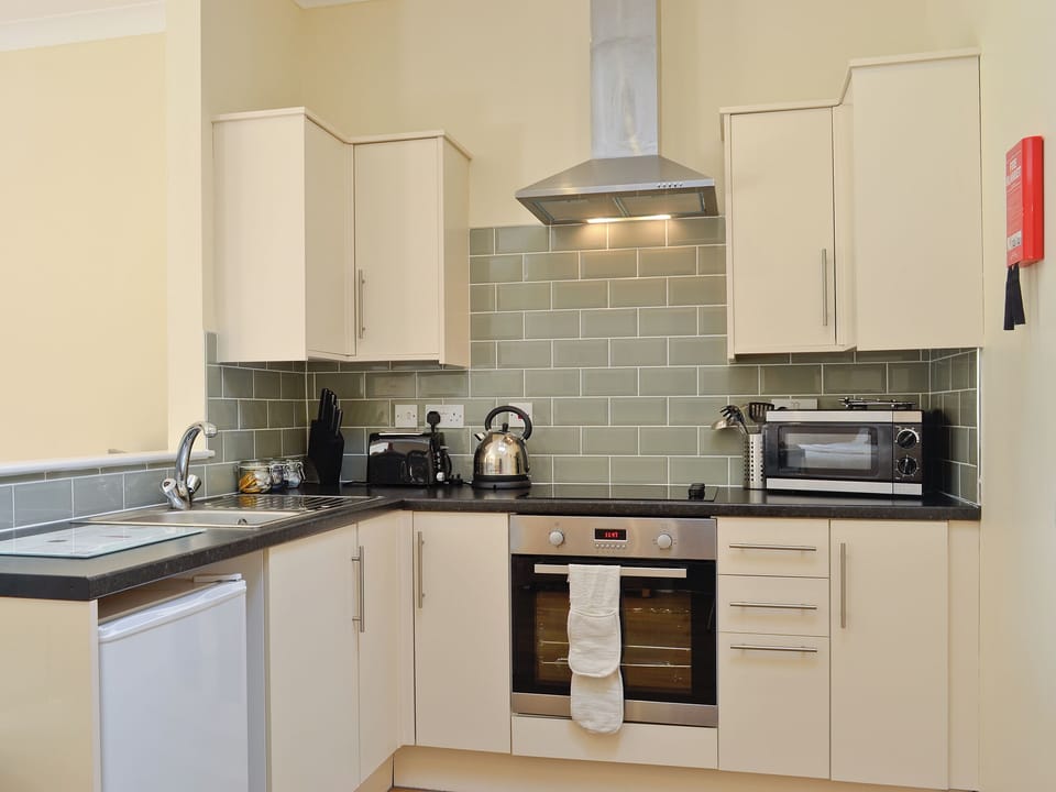 Open plan living/dining room/kitchen/bedroom | Auchendennan - Chestnut Cottage, Arden, Alexandria
