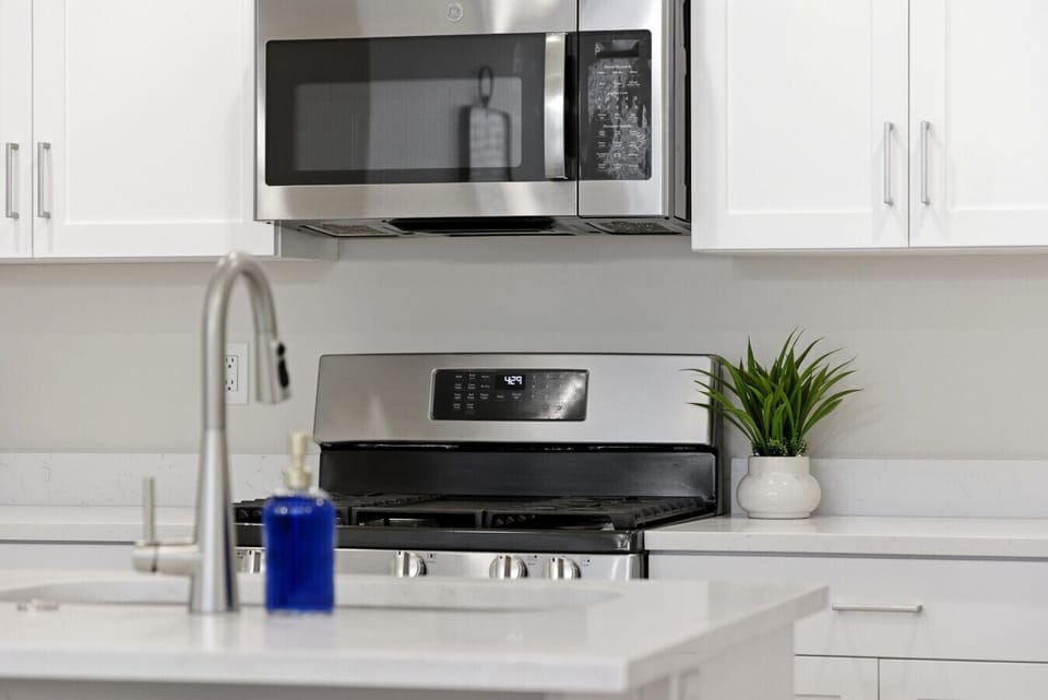 Kitchen: Sleek stainless appliances and stylish decor invite culinary adventures!