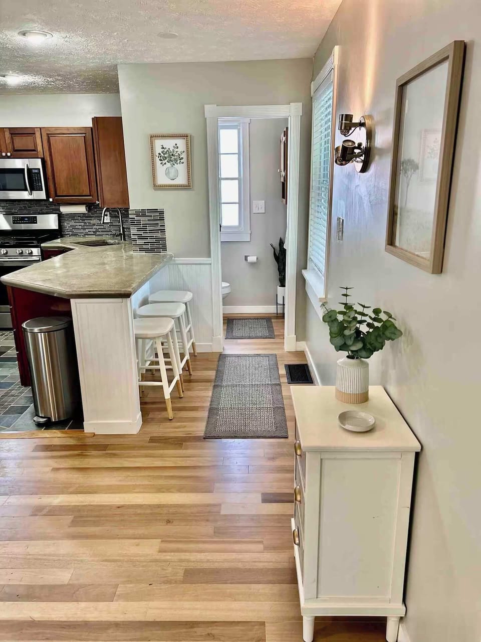View from main entrance to the half bath and kitchen. 