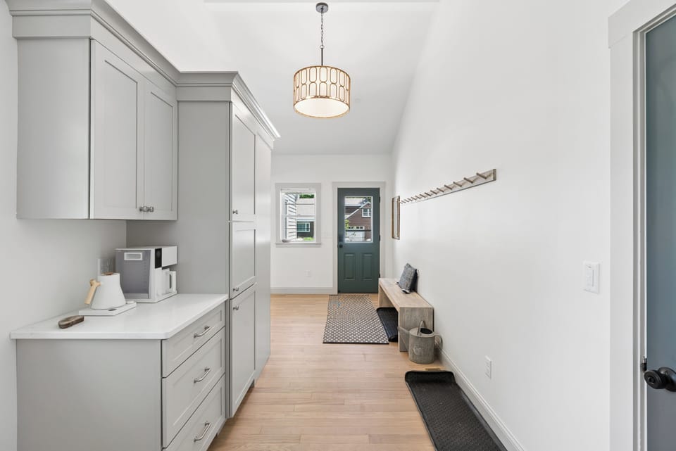This entry way has plenty of hooks for your coats plus coffee bar right off the kitchen. 