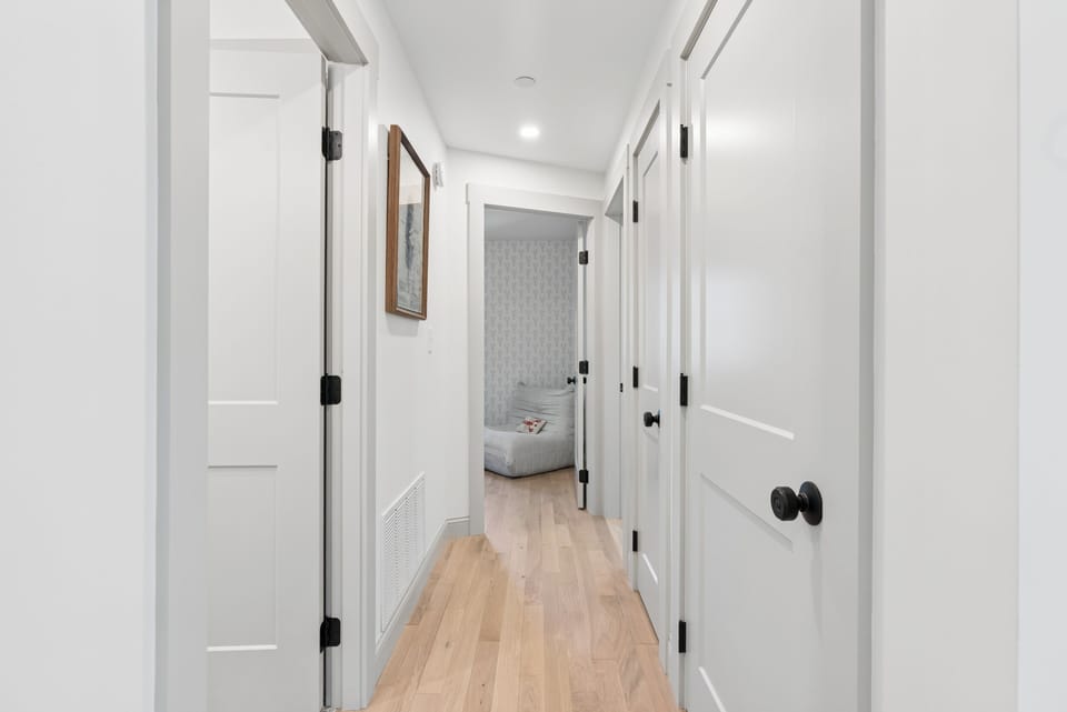 The downstairs hallway leads to Bathroom #1, Bedroom #1 & 2. 