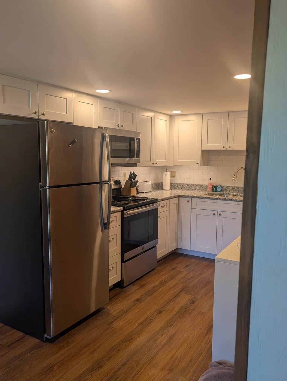 Brand new luxe kitchen with stainless steel appliances: microwave, fridge, stovetop and oven...