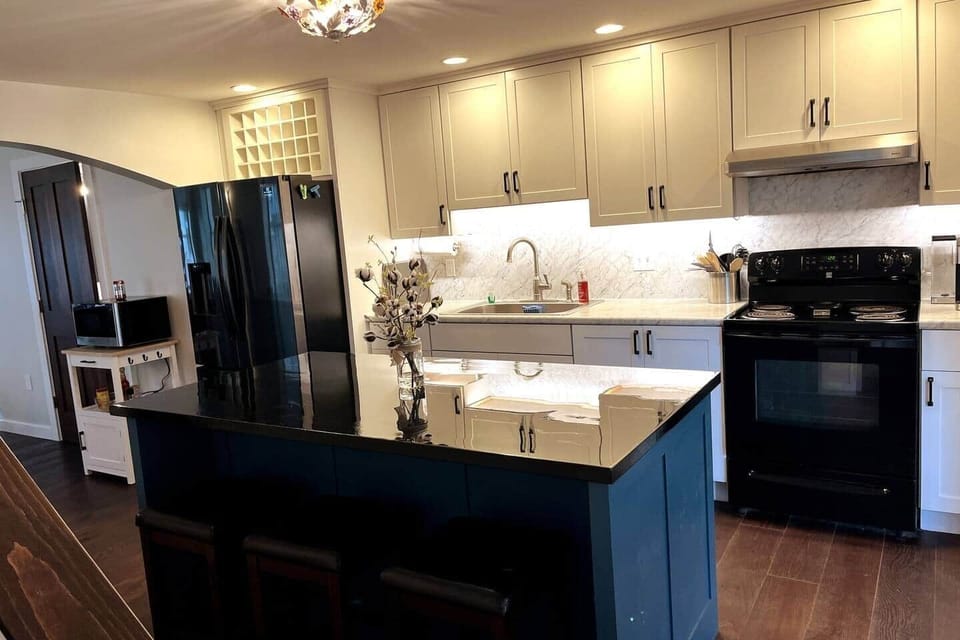The kitchen is beautiful and well-appointed, featuring a custom center island with 3-4 stools.