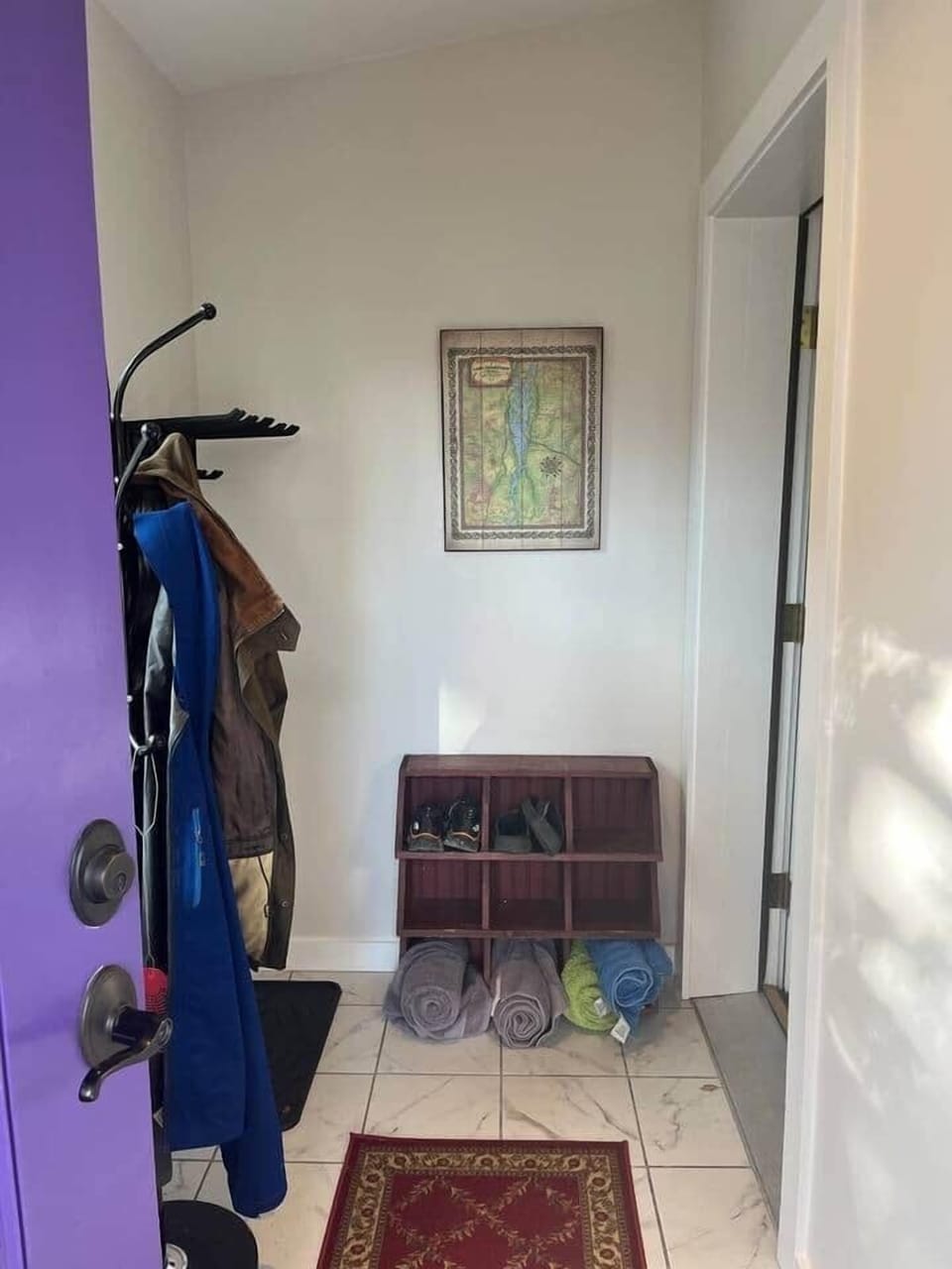 Entering the Purple Door Cottage, you will be greeted by a vestibule with a shoe rack, a coat rack, and a ski rack. 