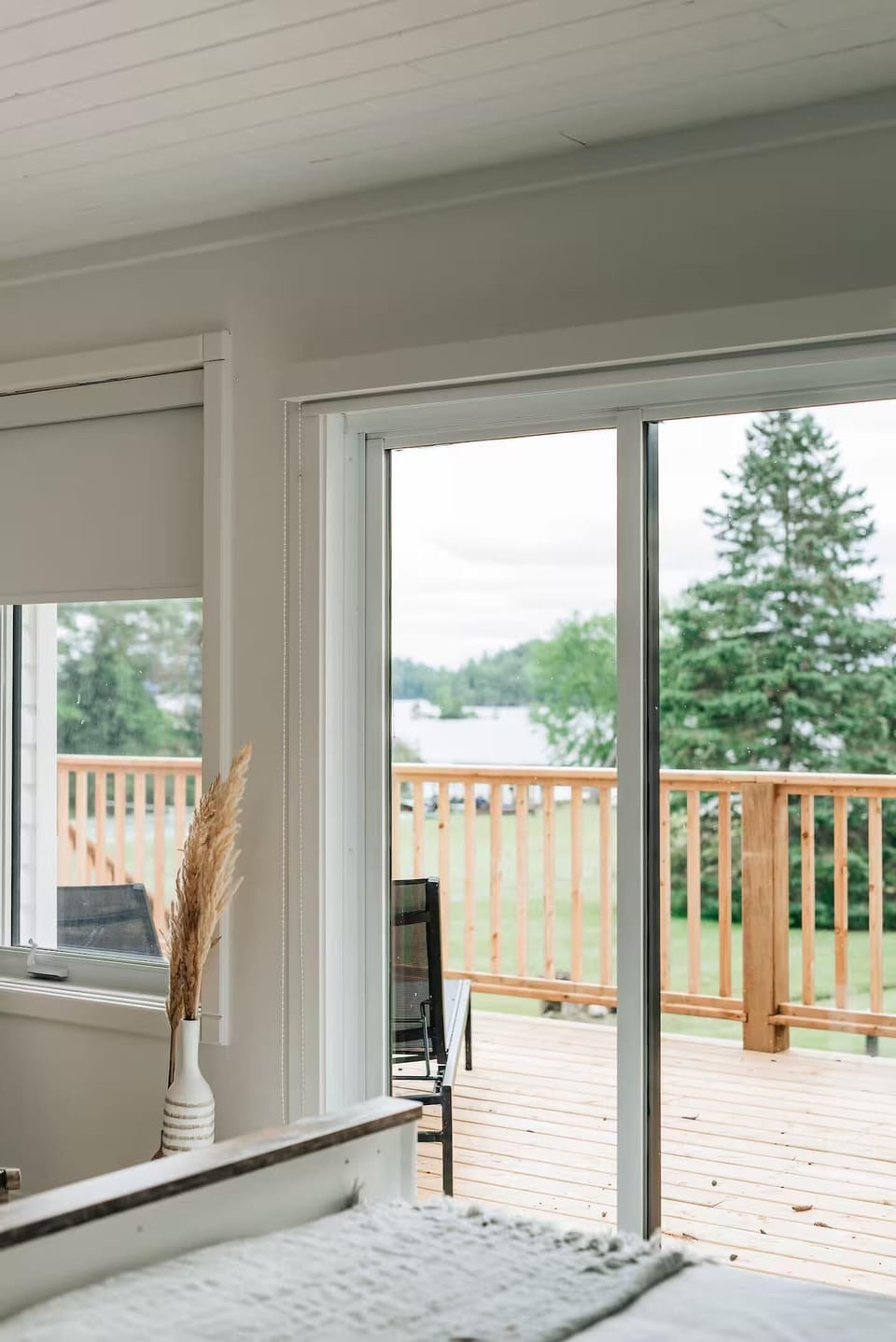 Bright living room with seamless deck access and scenic views