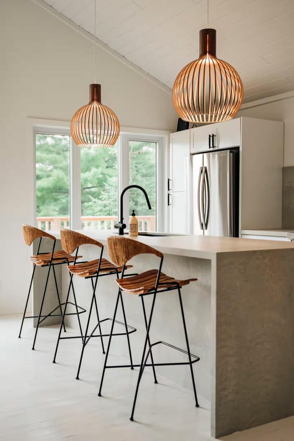 Modern kitchen bar with stylish pendant lighting and stools