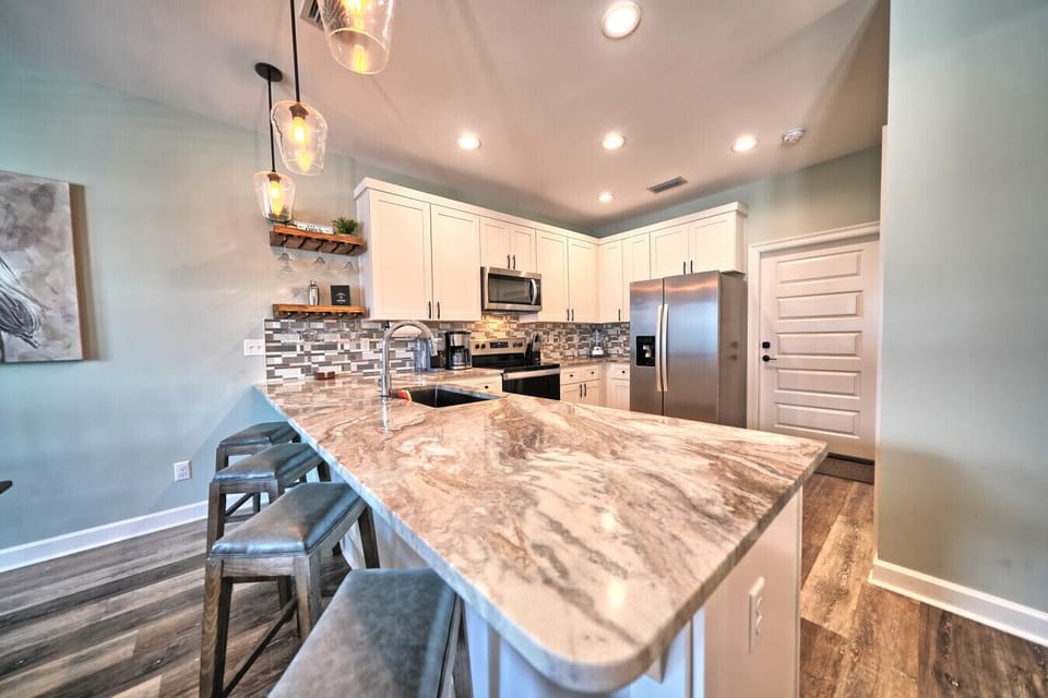 Prepare delicious meals in the fully equipped kitchen, featuring stunning countertops, sleek stainless steel appliances, and ample cabinet space! Enjoy casual dining at the breakfast bar with comfortable seating for three.