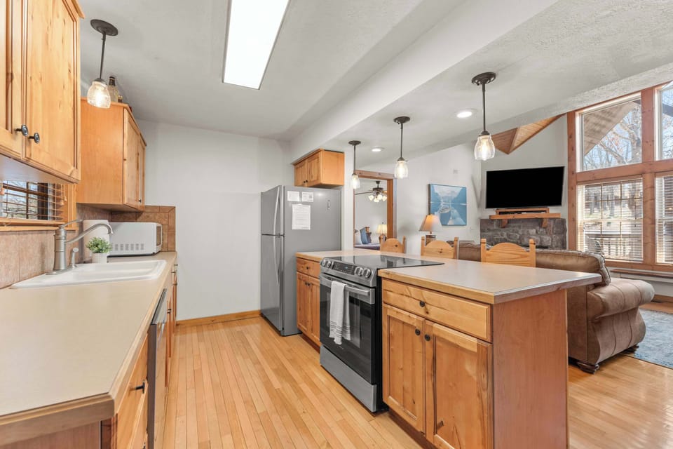The open concept allows everyone to be part of the fun, whether cooking in the kitchen or relaxing on the couches.