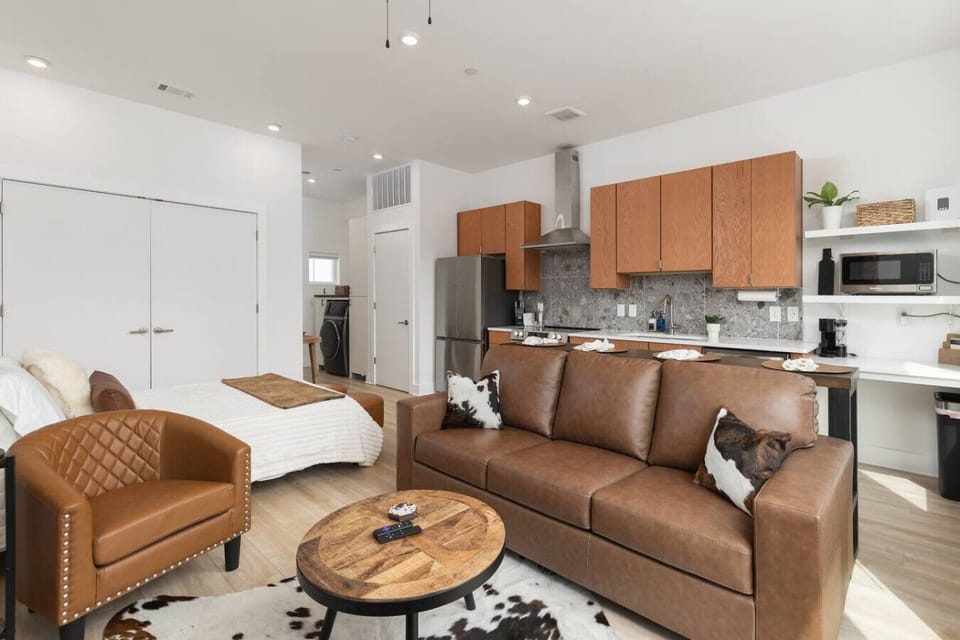 Bright living area filled with natural light. Featuring comfortable seating with a sofa bed, a Smart TV and an electric fireplace.