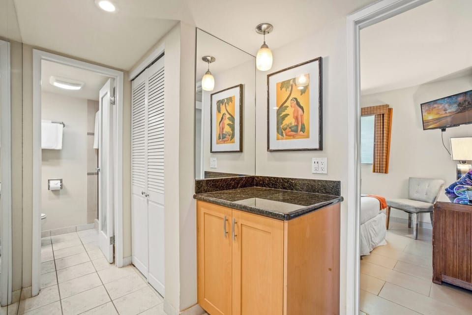     A serene guest bathroom with a walk-in shower, modern fixtures, and textured tile accents for elevated comfort