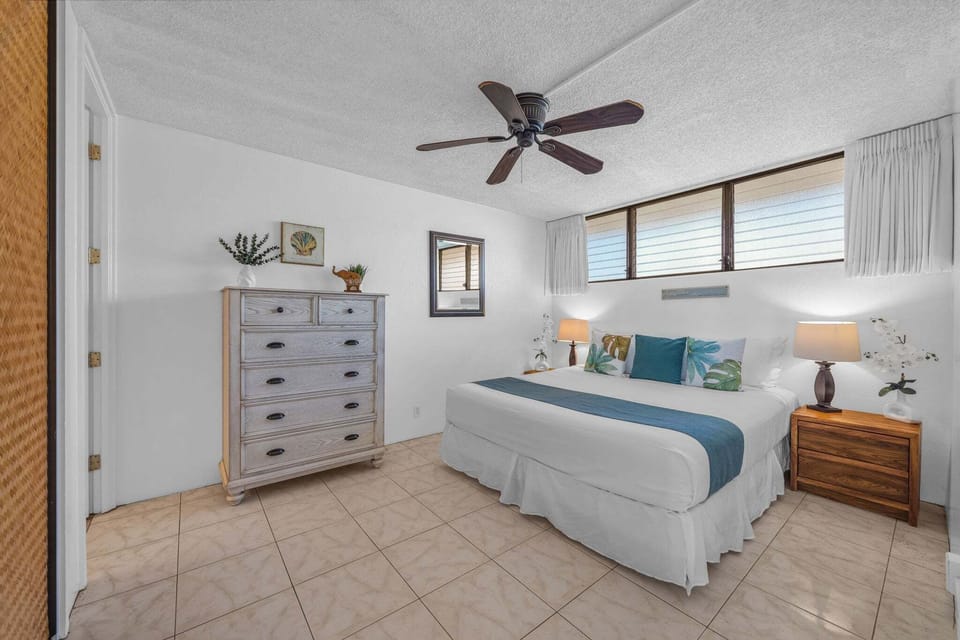 Spacious bedroom with calming tones and cozy finishes.