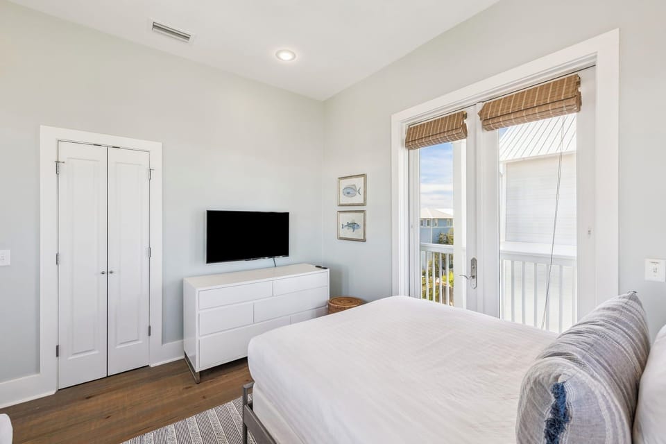 Luxurious Guest Bedroom with Two Queen Beds and a Stunning Patio View