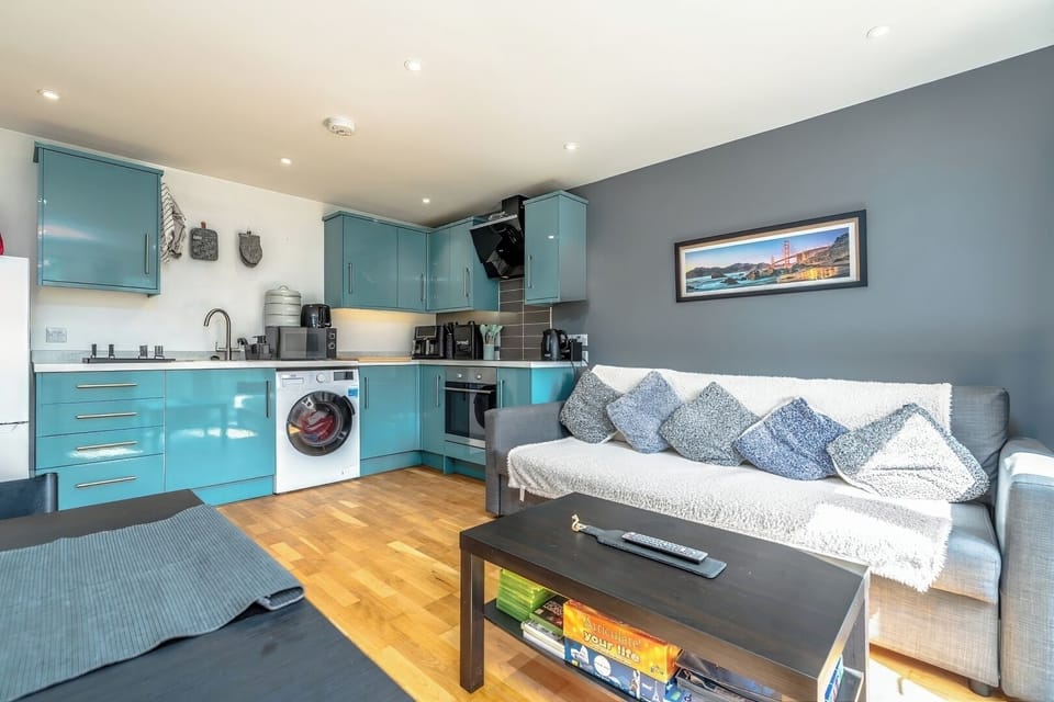 - Contemporary kitchen with teal cabinets   - Comfortable sofa lounge with smart TV   - Spacious design for group gatherings