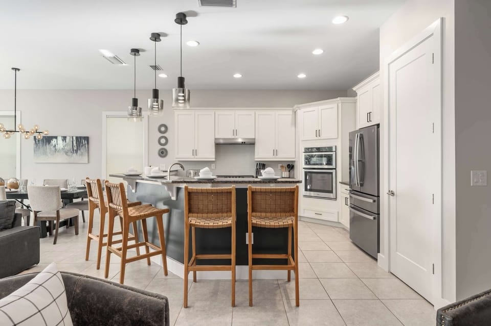 Spacious kitchen w/ oversized island seating & stainless appliances throughout