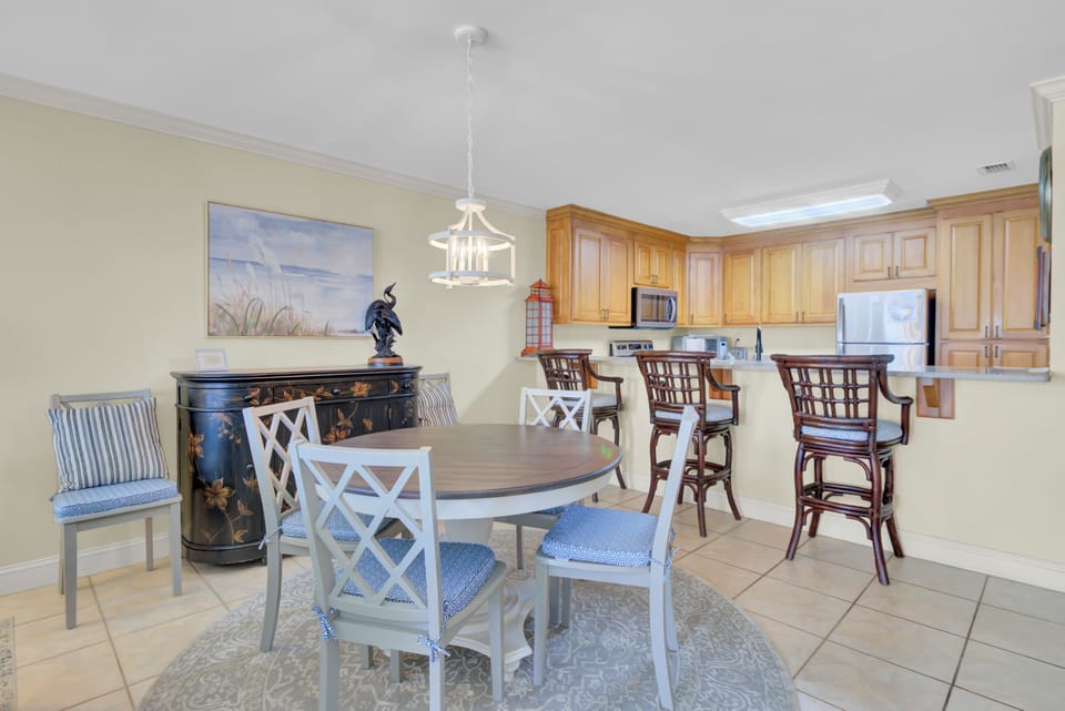 Large dining space next to a fully equipped kitchen.
