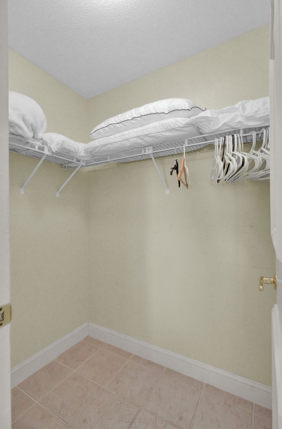 Laundry closet with linens and storage.