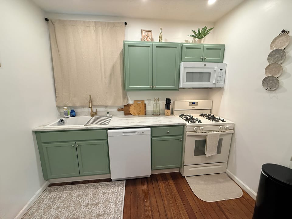 Fully equipped kitchen with gas range and dishwasher.