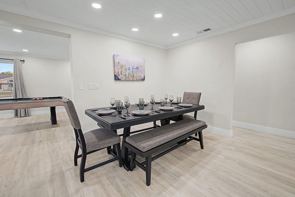Your modern dining space awaits memorable meals with stylish seating for six and a fun pool table nearby.