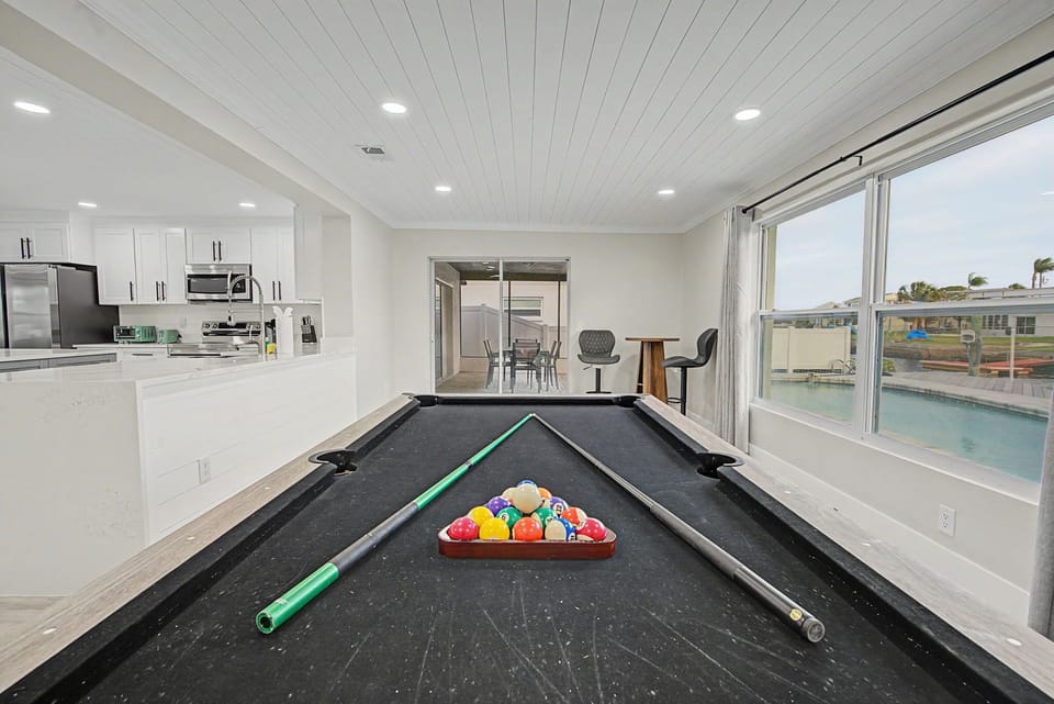 Challenge friends to a game on your private pool table while enjoying the bright, open-concept space with kitchen and pool views.